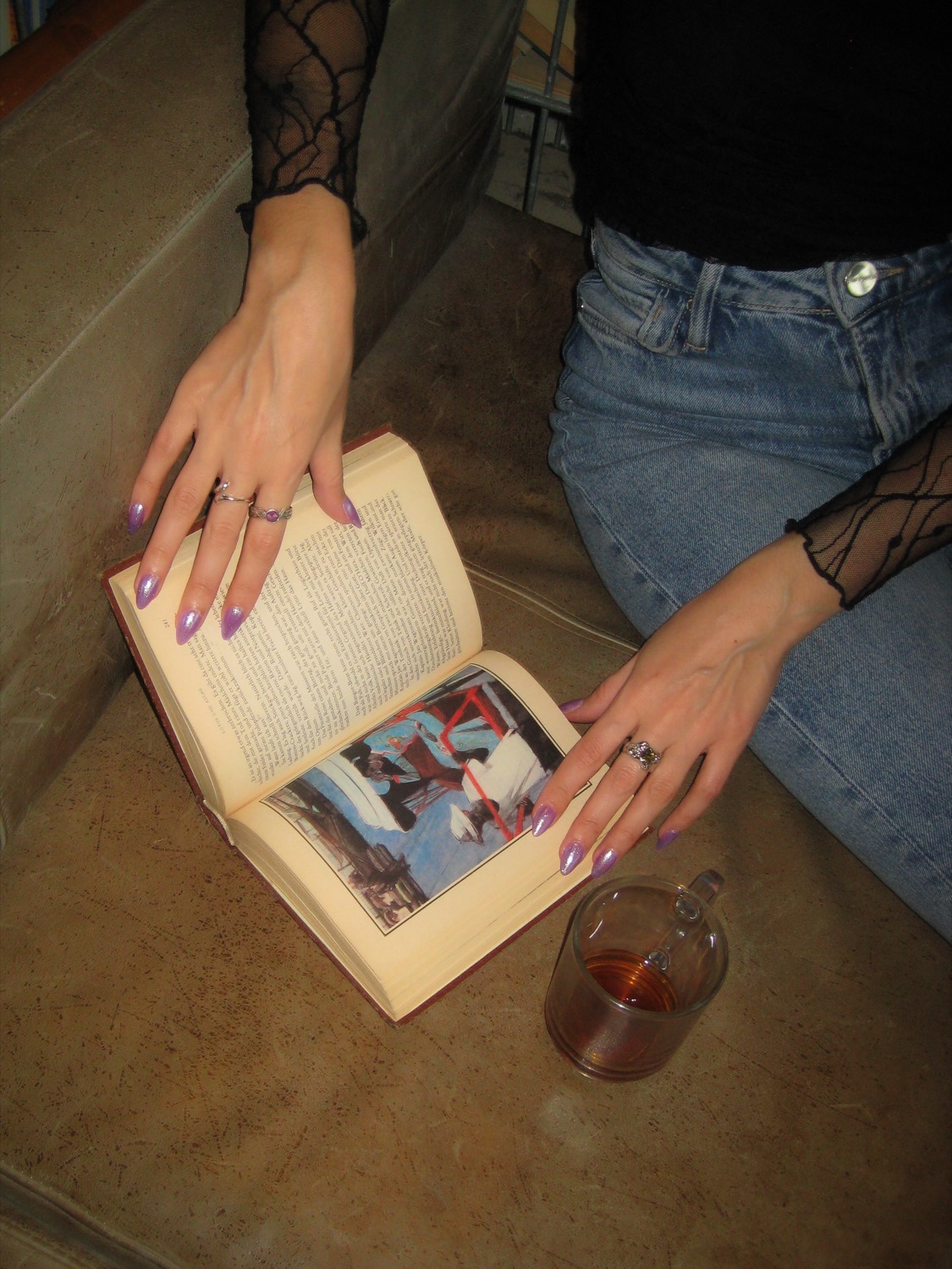 Reading a book with a cup of tea